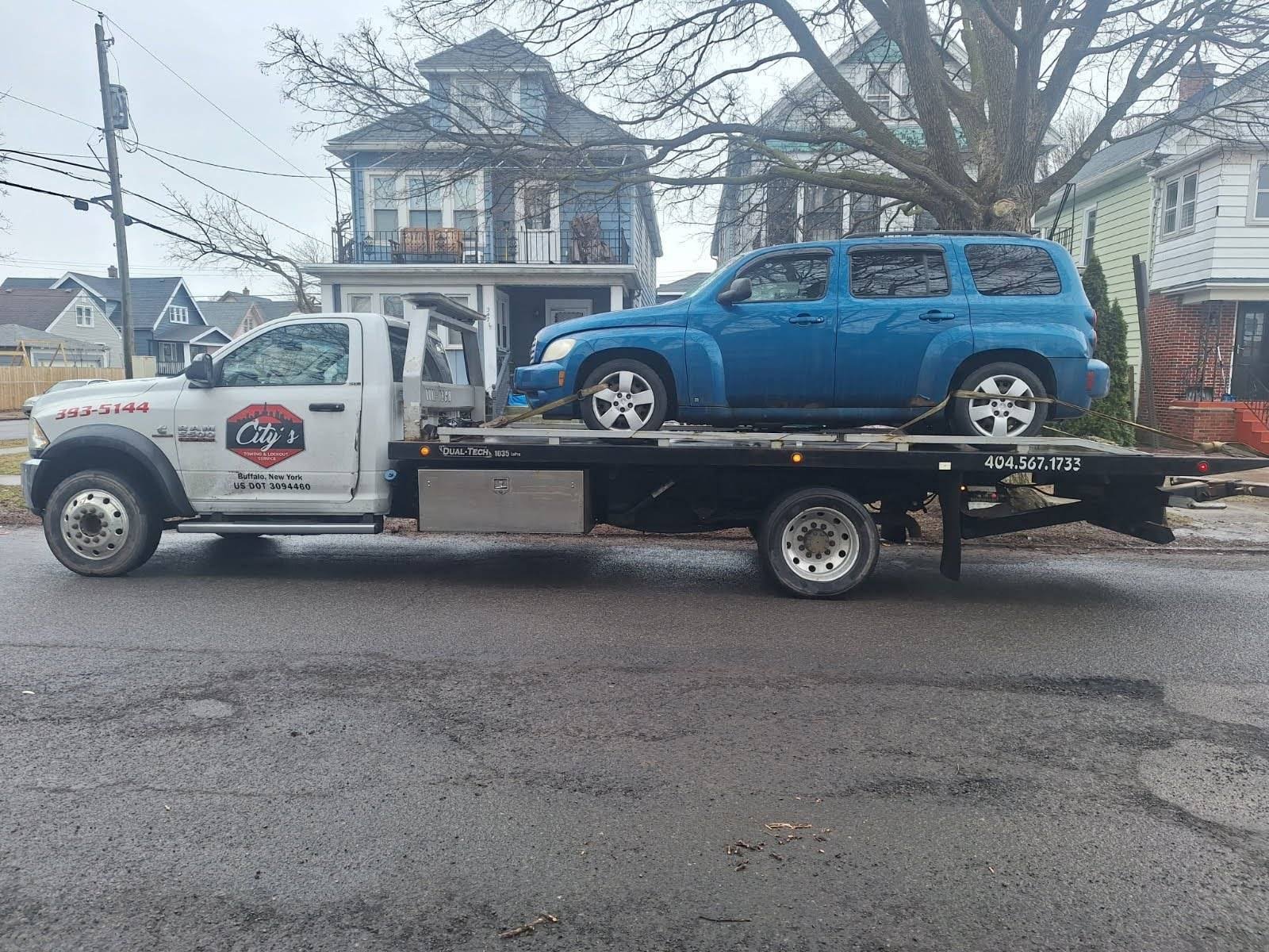 Blue SUV on flatbed tow truck Buffalo