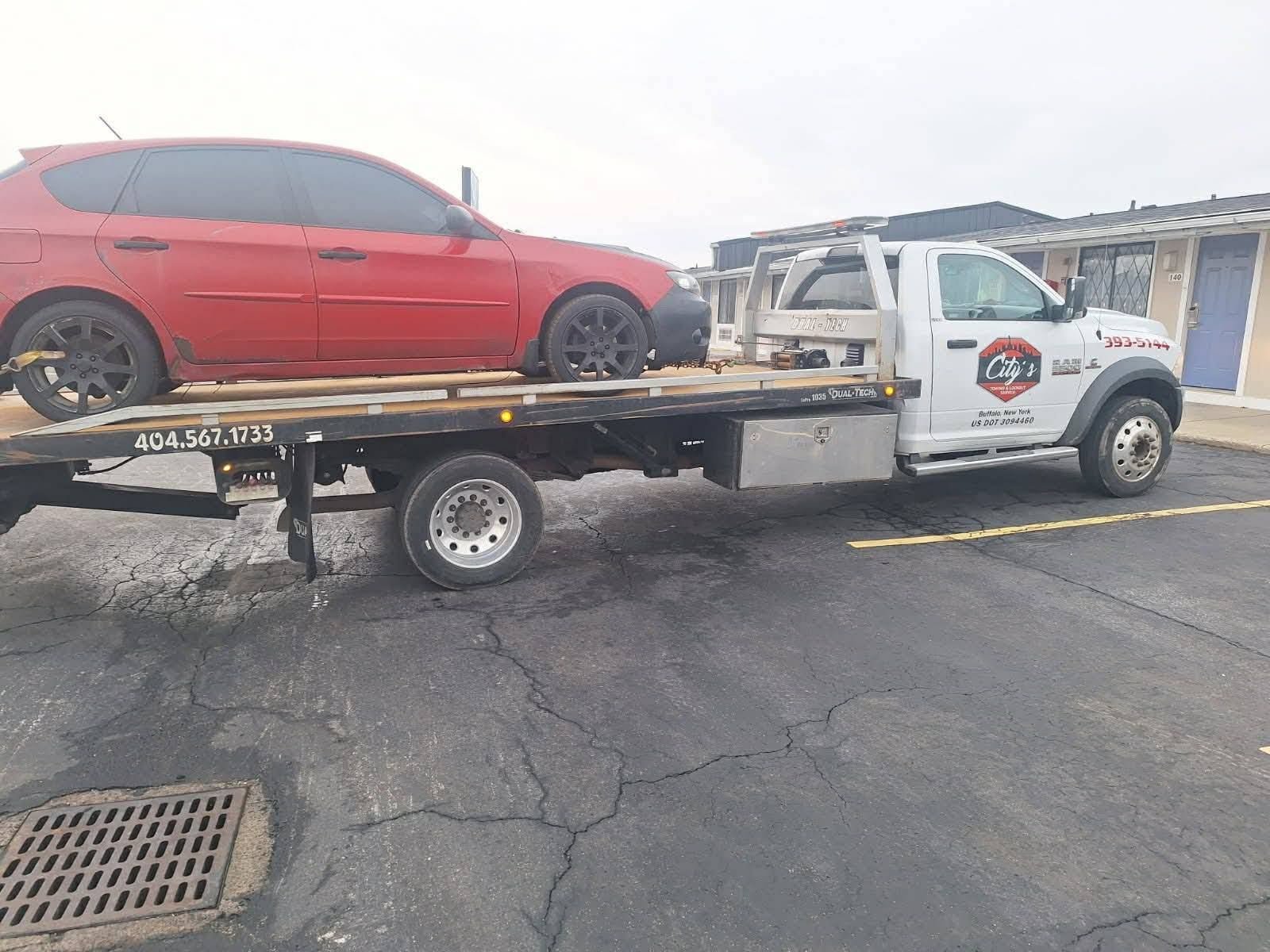 Red car flatbed towing